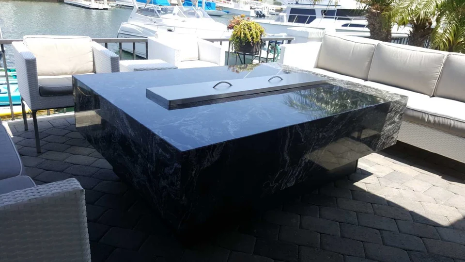 Granite fire pit table on a waterfront patio in San Diego
