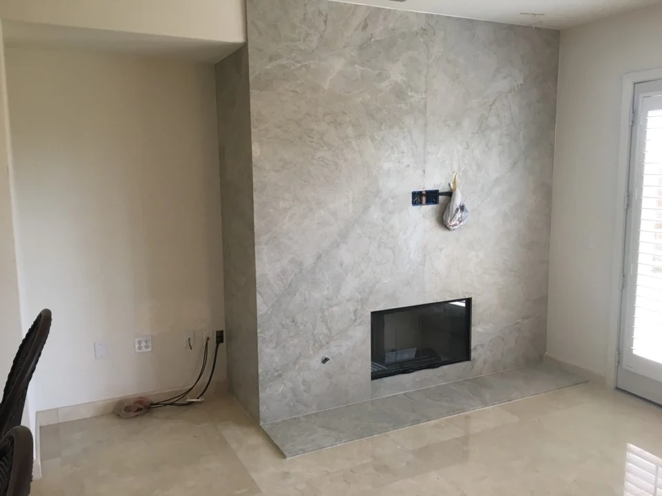 Full-height stone slab fireplace wall in a San Diego home