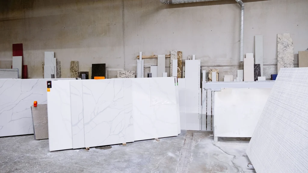 Quartz and stone slabs lined up inside a fabrication shop